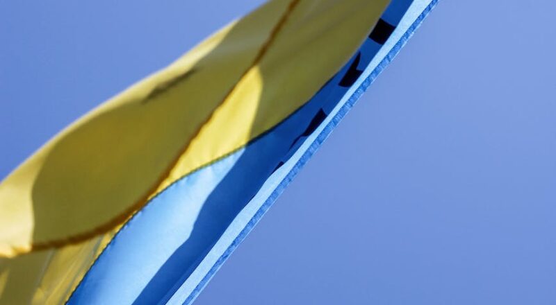 ukrainian flag waving in wind with clear sky in background